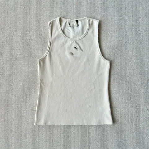 Off-White Ribbed Tank Top with a Distressed Worn-In Look · Off-White